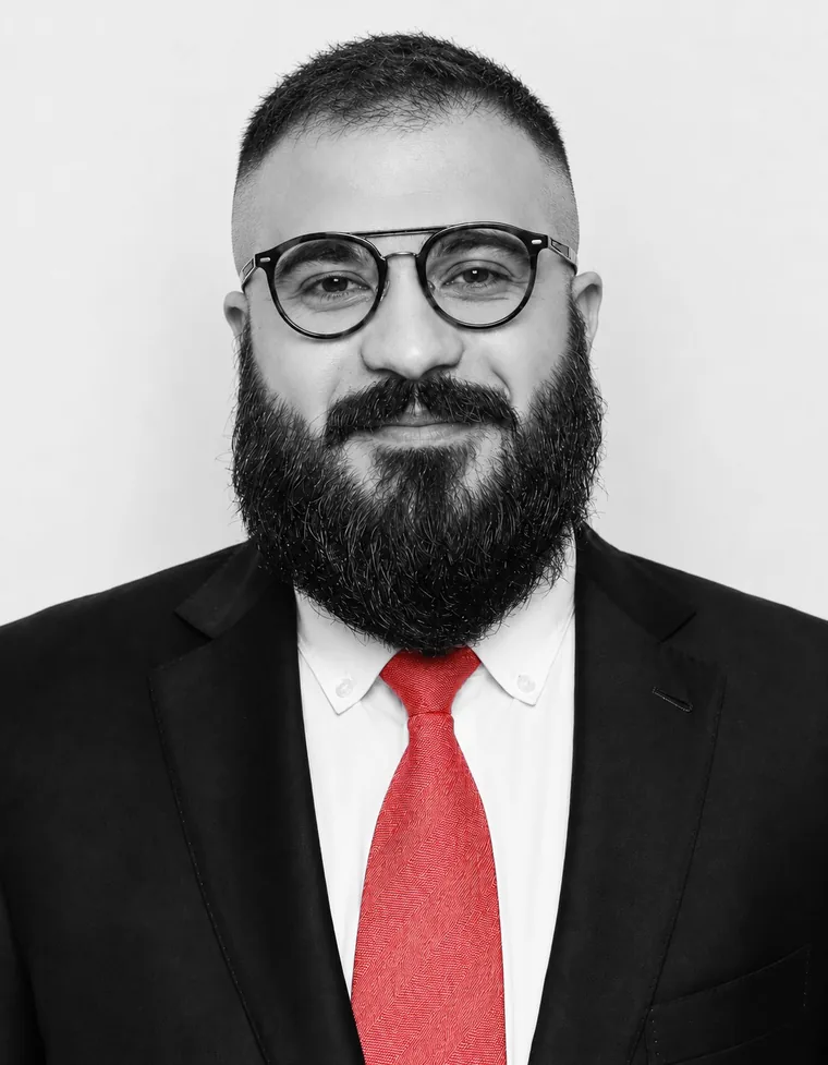 Timur Gadzhiev, founder of Lita VC, in a dark suit and a red tie